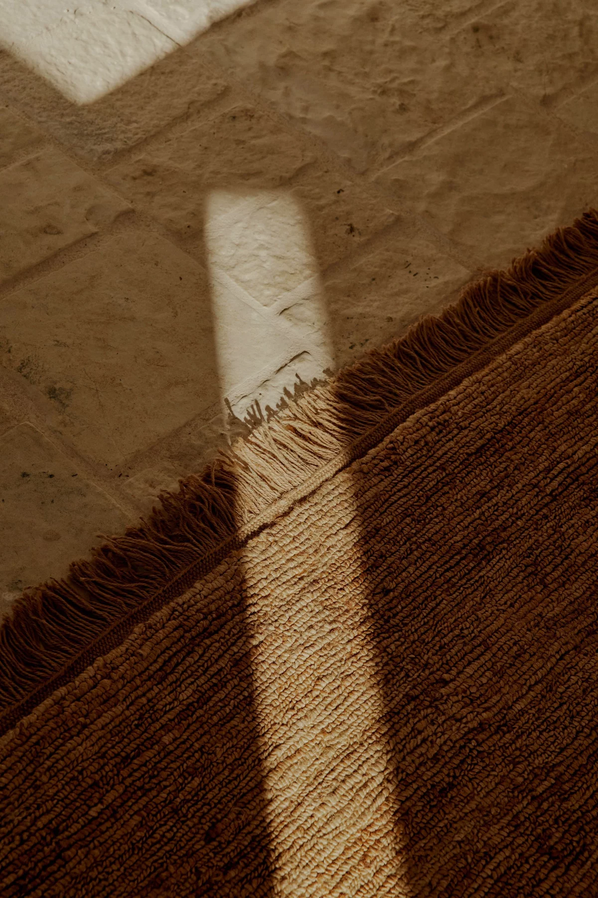 Luxury rug texture and fringe detail — the material quality that earns specification