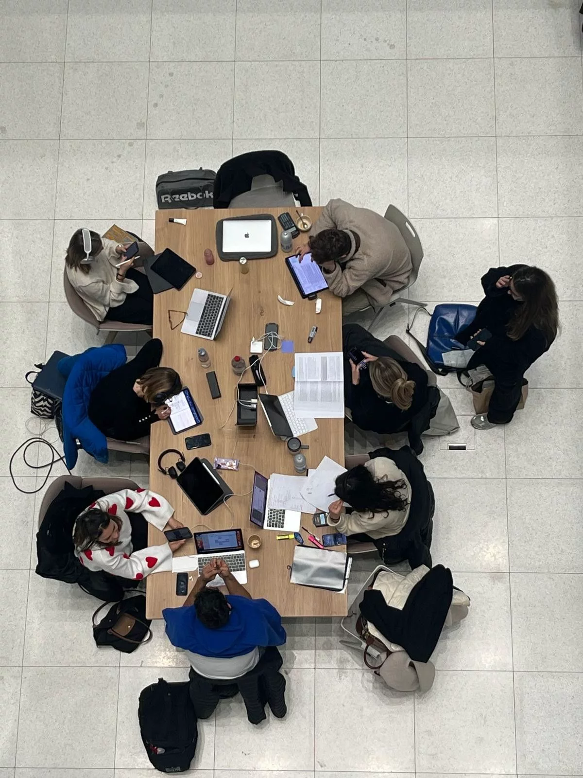 Textile sourcing team reviewing fabric selections — the moment platforms need to be present